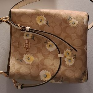This is a coach flower medium size tote bag.